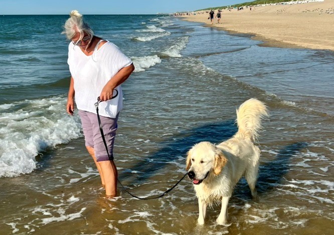 Jutta Koch and golden retriever at the beach