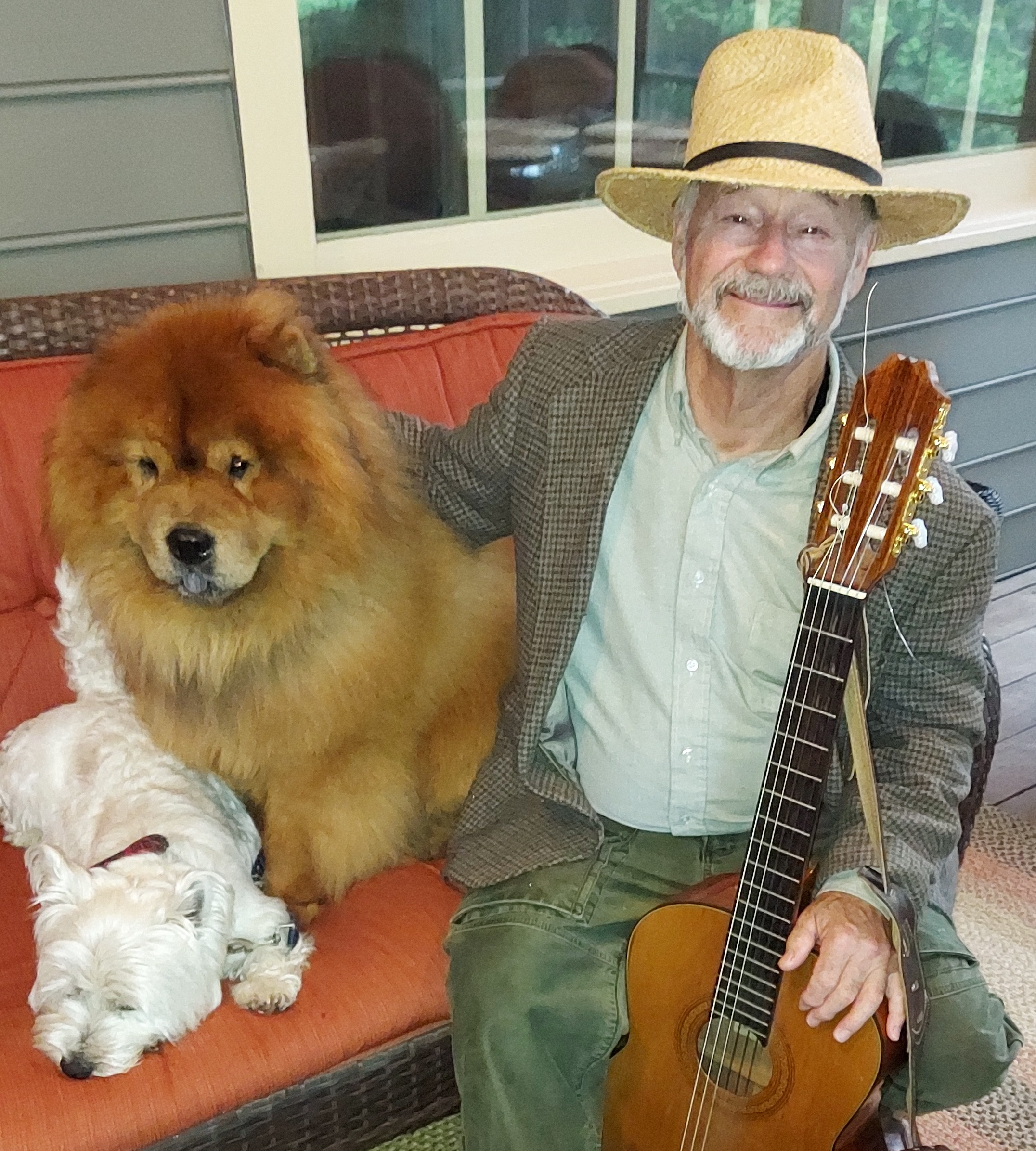 VSA-certified dog trainer Kent LaRue with his two dogs and guitar